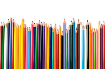 Colored pencils in a row isolated on white background.