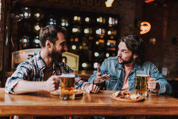 Friends chatting and enjoying drinks at pub