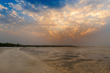 View of a beautiful deserted beach in the island of Orango at sunset, in Guinea Bissau. Orango is part of the Bijagos Archipelago; Concept for travel in Africa and summer vacations