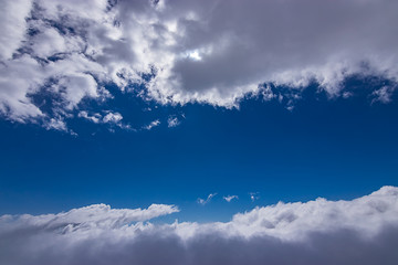 Fototapeta na wymiar some fluffy white clouds and bright blue skies