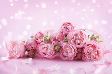 Beautiful rose flowers on pink background. Greeting card or banner for Womens day or Mothers day.