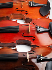 Fototapeta premium Three violins background,show detail of the instrument