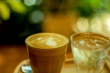 Morning hot latte coffee in the cafe, breakfast at a background.
