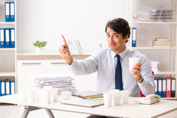 Naklejka premium Young employee addicted to coffee