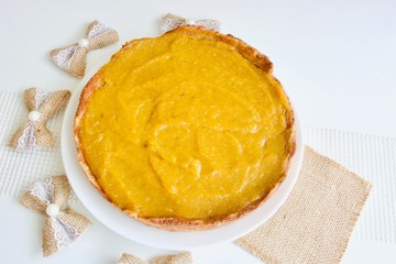 Tasty pumpkin spice pie on the white table