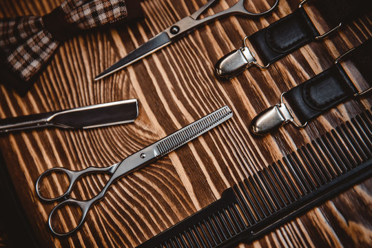 Tools for male hairdresser, elements of style and image barber. Wooden background. Close up