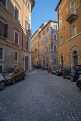 Fototapeta na wymiar Narrow cobblestone street of Rome