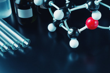 molecular formula and laboratory equipment on a blue background with copy space. Science organic...
