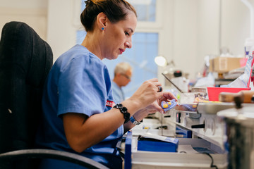 Caucasian woman working on a dental prosthesis