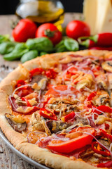 Mexican spicy pizza and ingredients on a wooden table. Traditional Italian cuisine. Party food
