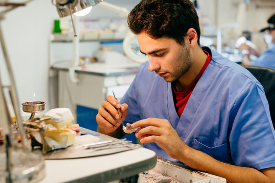 Caucasian man working on a dental prosthesis