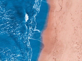 Concept Yin Yang. Sandy beach is washed by blue water. Top view