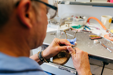 Caucasian man working on a dental prosthesis