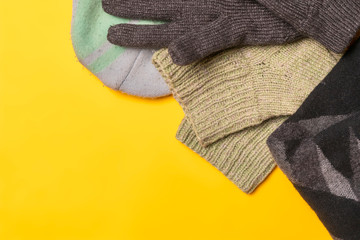flat lay of winter warm clothes supplies on color background f