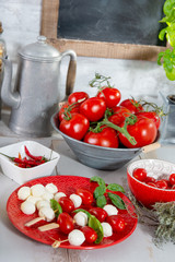 red plate with small tomatoes and mozzarella