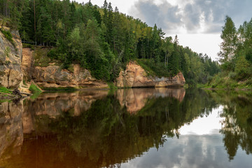Fototapeta na wymiar sandstone cliffs with tourist trail on river of gauja, Latvia