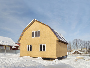 Construction of small country house in winter time