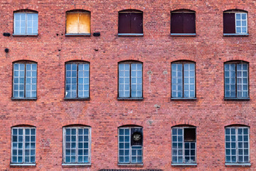 Fototapeta na wymiar Windows on red brick wall