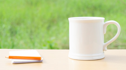 hot coffee white mug and yellow pencil on a wooden table natural background,with copy space for your text..