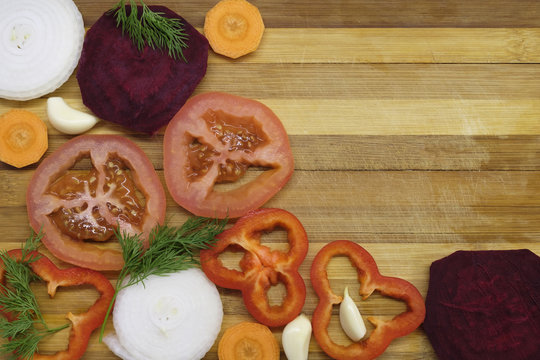 Sliced tomato, pepper and carrot on the table close-up