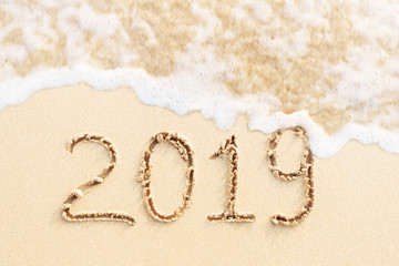 New year concept. 2019 written on the beach.