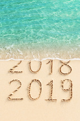 New Year concept - 2018 and 2019 written on the beach