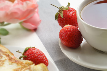 Fresh, tasty strawberries for breakfast on a light background.