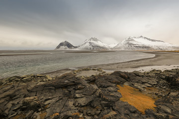 Snowy mountain, sea and beach