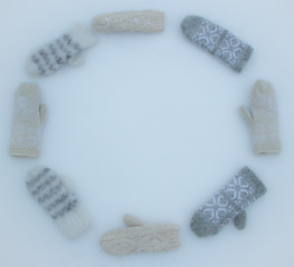Knitted winter mittens grey and beige, soft texture, warm and cozy winter mood photography