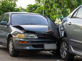 Car crash accident on street with wreck and damaged automobiles. Accident caused by negligence And lack of ability to drive. Due to illness