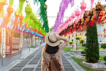 A woman tourist is enjoy traveling at Wat Benchamabophit Dusitvanaram Marble Temple Bangkok‎ during decoration with Yipeng Lanterns festival. © BUSARA
