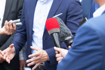 Journalists making media interview with businessperson or politician at news conference