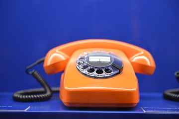 Old-fashioned retro 1960`s phone on blue background 