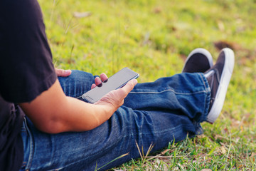 Lifestyle of business person using smart phone via 4g internet to post and share to social media.Relaxing Time,Young blogger searching on digital device in park,Technology Concept