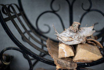 Birch firewoods at black grill, preparing of food at countryside, village mood background