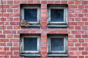 Four square windows on brick wall