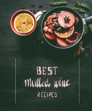 Fototapeta Christmas mulled wine in a pan and in a cup on a black wooden background with an inscription and space for text
