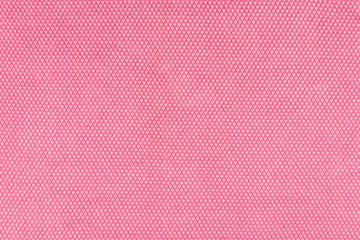 Real, pink knitted fabric fragment made of synthetic fibres textured background, with delicate pattern.