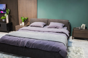 Luxury studio apartment in a loft style in dark colors. Stylish modern cozy bedroom area