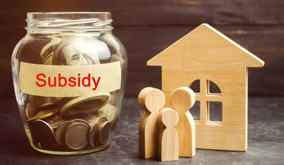 The family is standing near a glass jar with the inscription Subsidy. Financial aid, support to the population. Cash grants, interest-free loans. Tax breaks, insurance, low-interest loans