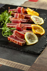 Naklejka na ściany i meble rosted tuna on black slate
