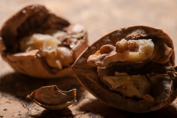 Brown premium raw organic walnuts on natural cork background.