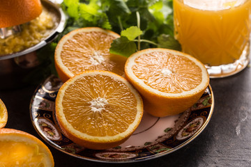 Fresh oranges juicer juice tropical fruits and herbs on concrete board
