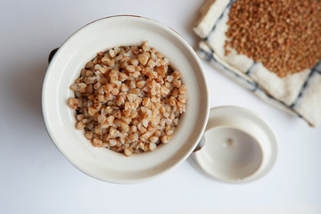 Soaked buckwheat in a clay pot, top view