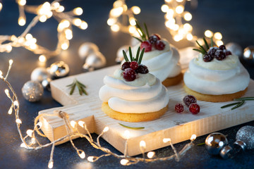 Pavlova Cake with berry cranberries on blue background