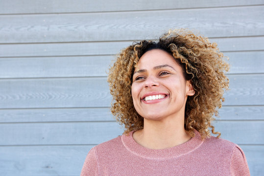 Close up horizontal beautiful african american woman smiling against gray background