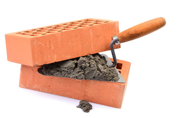 Red bricks and tools for laying on a white background
