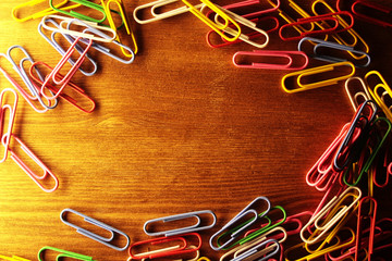 paper clips on wooden background