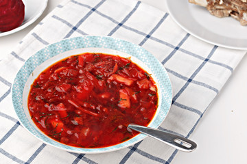 Russian and ukrainian national food - red beet soup, borscht . Closeup