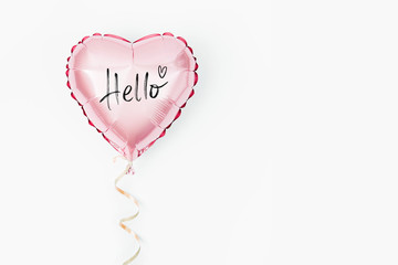 Single Balloon of heart shaped foil on white background. Love concept. Holiday celebration. Valentine's Day or wedding/bachelorette party decoration. Metallic balloon